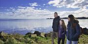 A family walking along side the water at Ballyronan marina