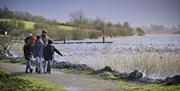 Family walking along the shores of lough Fea.