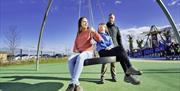 A family on a tire swing