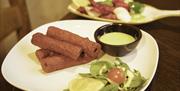 A plate of Indian meats and salad