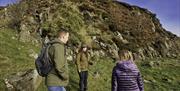 A tour guide with walkers on a mountain route