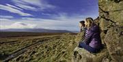 A couple looking at the view from the mountain