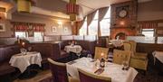 The seating area with tables and chairs in a restaurant