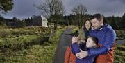 Family with young boy pointing his phone into the sky