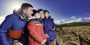 Family looking up into a bright blue sky