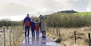 Family walking on boardwalk