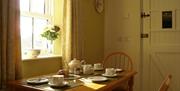 dining area with table and 2 chairs in image
