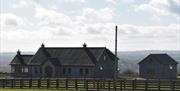 Image of a Bungalow and garage from across a field