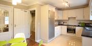 open plan kitchen and dining area with amenities