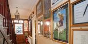 hallway inside with photos on the wall opposite staircase