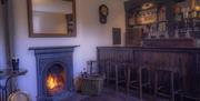 bar area with fireplace and bar stools