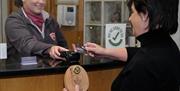 Woman purchasing a clock and paying with a mid ulster gift card