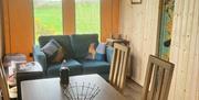 A dining table and sofa inside the accommodation