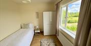 single bed, wardrobe, bedside table, countryside view