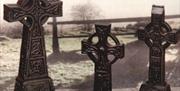 three Celtic crosses made from turf