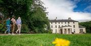 Three girls walking towards the front of Lissan House