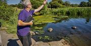 Jim throws a stone into Lough Neagh which has a symbolic meaning in the Poetry & Prayers experience