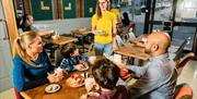 A family being served a meal in the Food Doc