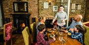 A family being served by a waitress