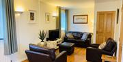 Living room with leather seating and TV area.
