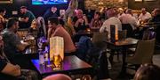 A crowd sitting in the bar at the Taphouse