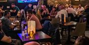 A crowd sitting in the bar at the Taphouse