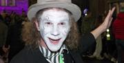 Man with face painted white