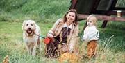 Hallowee'uns: Lady with dog and small child picking a pumpkin