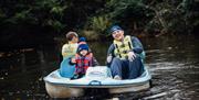 Hallowee'uns: Man with a small child on a peddle boat