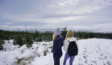 Two girls overlooking the snowy Sperrins