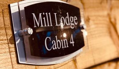 Sign of mill lodge cabin 4