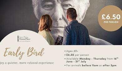 A couple looking at an image of Seamus Heaney