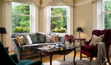 Image of a patterned sofa and two arm chairs in Ardtara house