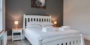 Beautiful white wooden bed with modern grey colour scheme