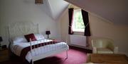 double bedroom with double bed and 2 armchairs