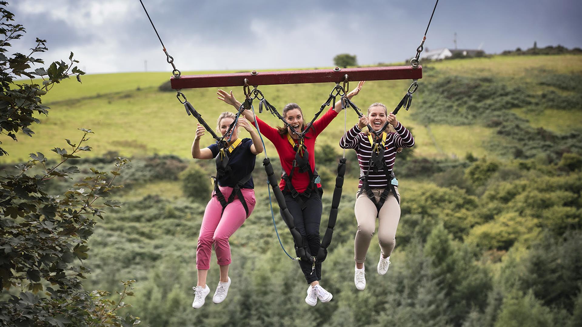3 girls on a Giant Swing over treetops at Todds Leap