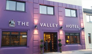 outside image of The Valley Hotel, with purple walls and black window frames and door