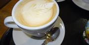 Image of a latte with leaf latte art