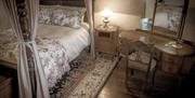 double 4 post bed with bedside locker and dressing table with mirror