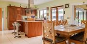 Kitchen and Dining area with wooden cabinets, island and patio doors