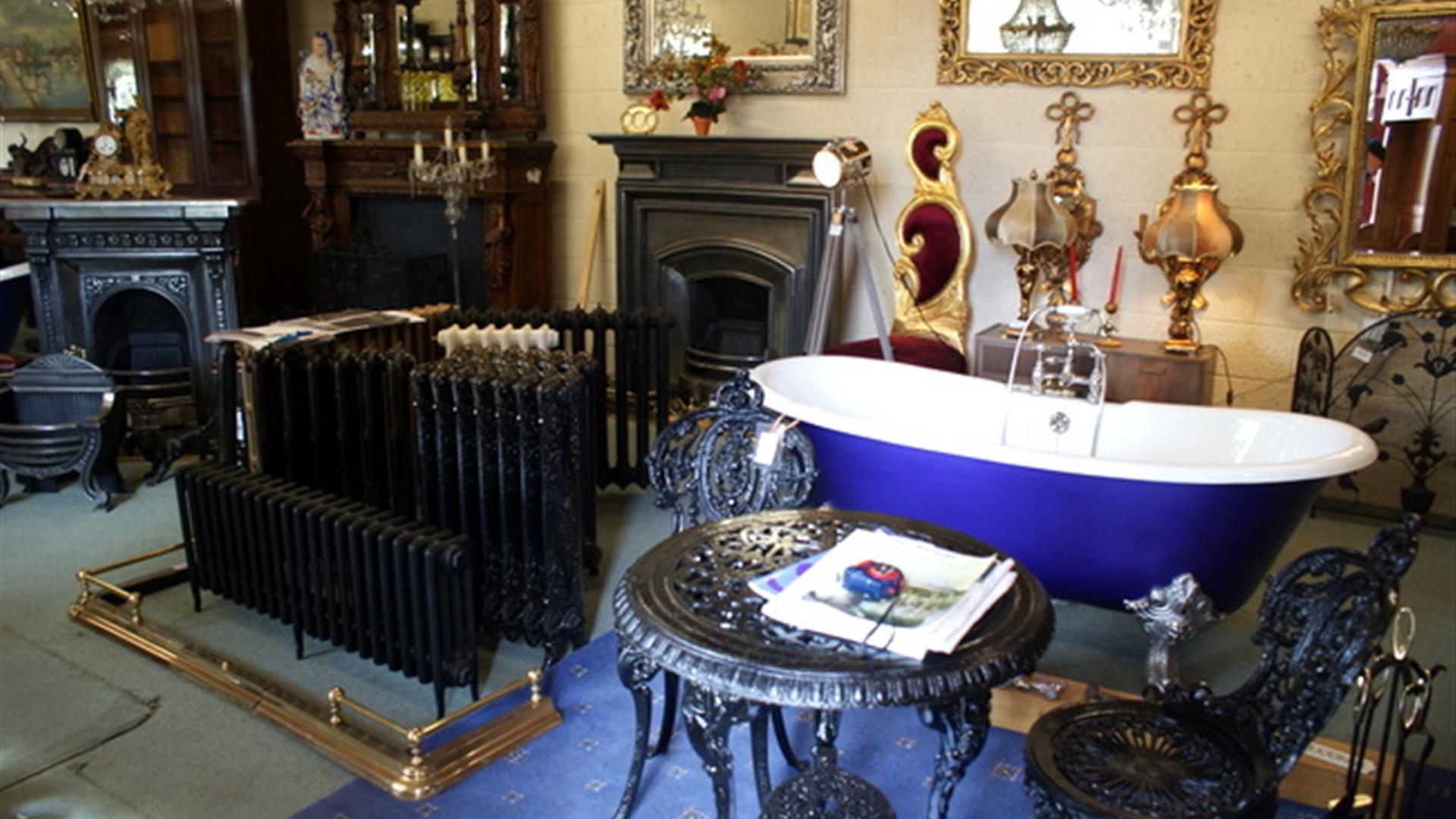picture showing an old bathtub, radiator, table and chairs and other antiques