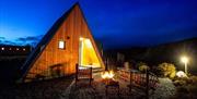 firepit and 2 chairs outside glamping pod