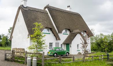 Outside view of Guest House with green car outside
