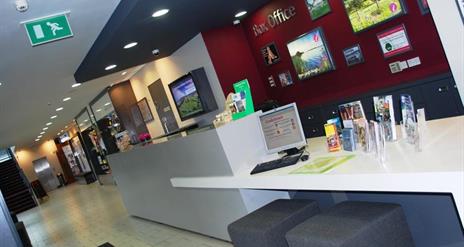 Image of the box office with a desk with various brochures