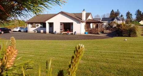 Outside view of house with large garden