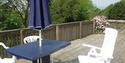 Outside decking area with table and 3 chairs