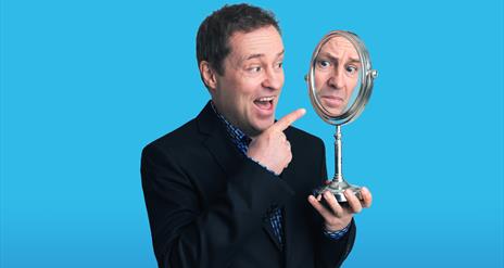Image of Ardal looking at himself in a mirror