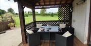 outside seating area with table and 4 chairs on decking