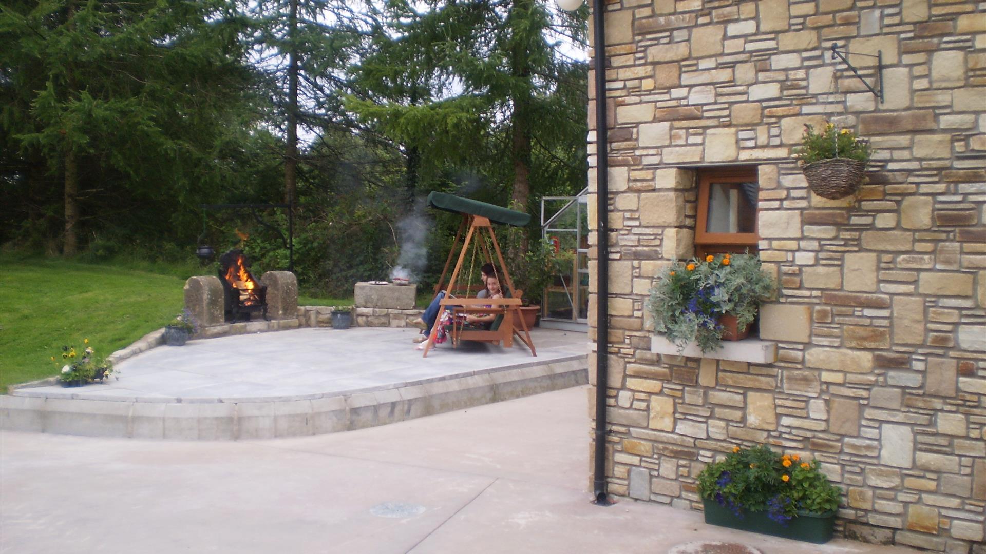 Outside patio area with firepit and wooden chair