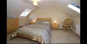 double room with bedside lockers and chest of drawers